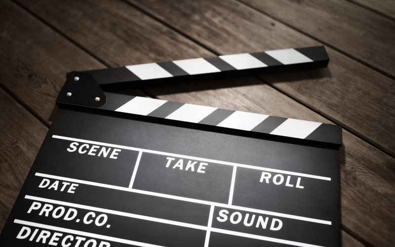 Film slate or movie clapper board on wood background